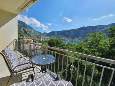 a balcony with a table and chairs and a view at Viola lux apartments in Kotor