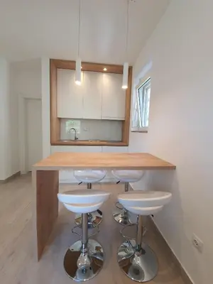 a kitchen with a counter and bar stools at Viola lux apartments in Kotor