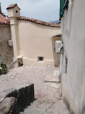 a building with a stone walkway next to a building at New renovated Old Town Martiva Apartment in Kotor