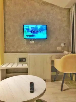 a living room with a television on a wall at Hotel Pierina in Budva