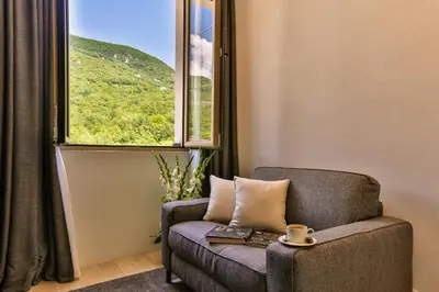 a chair sitting in a room with a window at Avanti Hotel & Spa in Budva