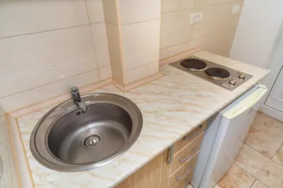 a sink in a small kitchen with a stove at Apartments Sara in Bar