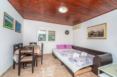 a bedroom with a bed and a dining table at Apartments Sara in Bar