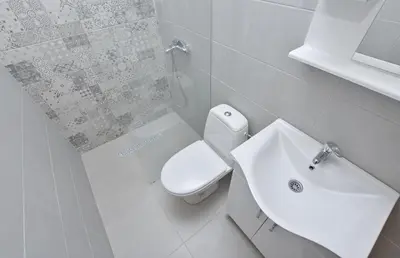 a white bathroom with a toilet and a sink at Rooms Sveti Toma in Virpazar