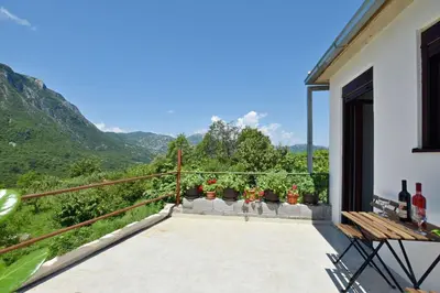 a balcony with a view of the mountains at Rooms Sveti Toma in Virpazar