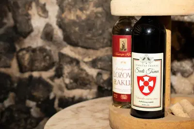 a bottle of wine sitting on a wooden table at Rooms Sveti Toma in Virpazar