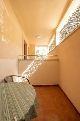 a dining room with a table and a window at Bel Mare Apartments in Budva