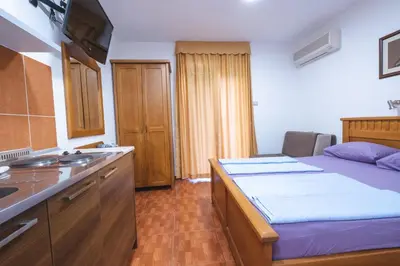 a kitchen with a bed and a sink in a room at Bel Mare Apartments in Budva