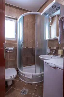 a bathroom with a shower and a toilet and a sink at Bel Mare Apartments in Budva