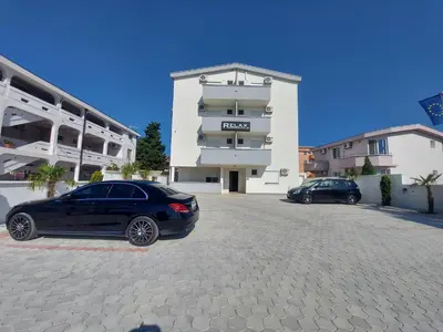 a black car parked in front of a building at Ulcin Relax Apartments & Rooms in Ulcinj
