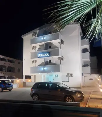 a car parked in front of a building at night at Ulcin Relax Apartments & Rooms in Ulcinj
