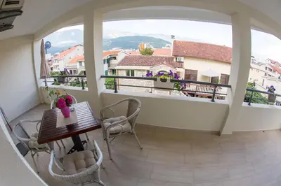a balcony with a table and chairs and a view at Guesthouse Dapcevic in Budva