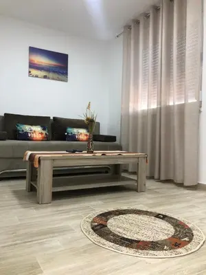 a living room with a couch and a coffee table at Stanovic Bungalow in Ulcinj