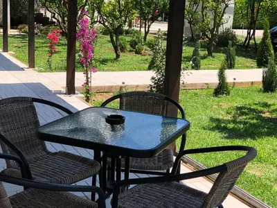 a black table and chairs sitting on a patio at Stanovic Bungalow in Ulcinj