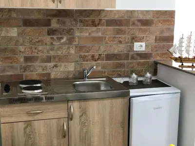 a kitchen with a sink and a stove at Stanovic Bungalow in Ulcinj