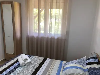 a bedroom with a bed with two towels on it at Stanovic Bungalow in Ulcinj