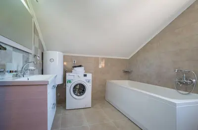 a bathroom with a washing machine and a washer at Villa Old Castle Apartments in Kotor