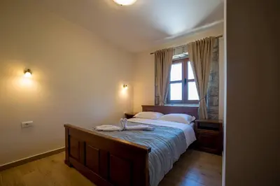 a bedroom with a large bed and a window at Villa Old Castle Apartments in Kotor
