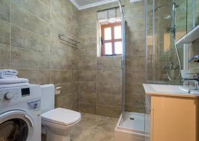 a bathroom with a washing machine and a sink at Villa Old Castle Apartments in Kotor