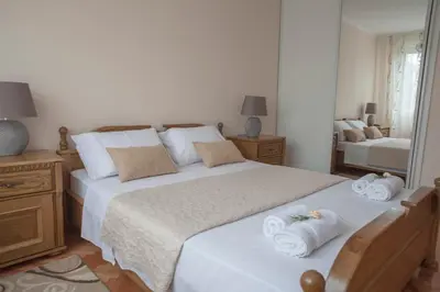 a bedroom with a large bed with towels on it at Apartman Preko Morace 2018 in Podgorica