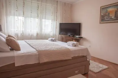 a bedroom with a large bed with towels on it at Apartman Preko Morace 2018 in Podgorica