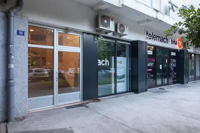 a store front with glass doors on a building at Apartman Preko Morace 2018 in Podgorica