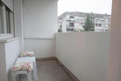 a small white room with a chair and a window at Apartman Preko Morace 2018 in Podgorica