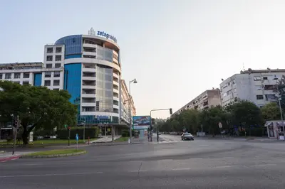 an empty street in front of a large building at Apartman Preko Morace 2018 in Podgorica