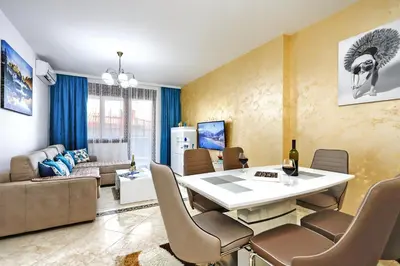 a living room with a white table and chairs at Apartment Anatolia Pekovic in Becici