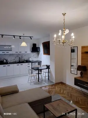 a living room with a table and a dining room at Apartments Natali in Bar