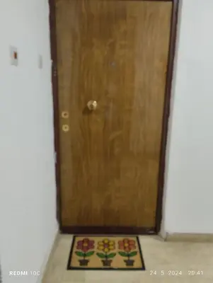 a wooden door with a rug in front of it at Apartments Natali in Bar