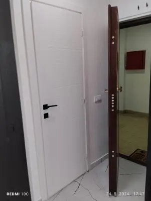 a white door with a black handle in a room at Apartments Natali in Bar