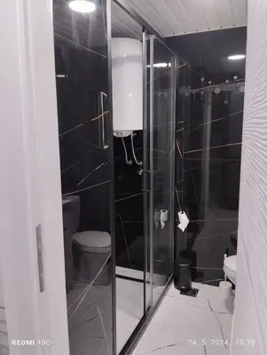 a bathroom with a toilet and a glass shower at Apartments Natali in Bar