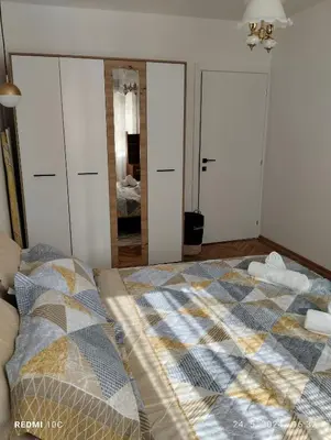 a bedroom with a bed and a mirror at Apartments Natali in Bar