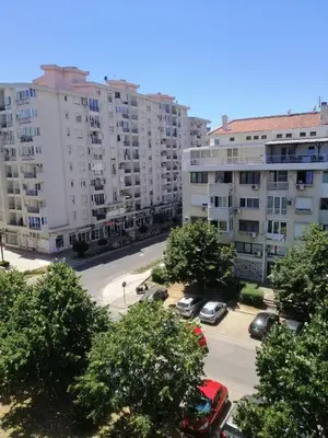 an apartment complex with cars parked in a parking lot at Apartments Natali in Bar