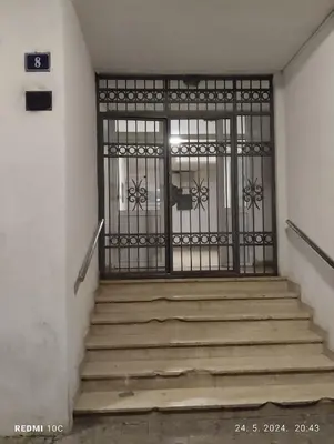 a metal gate with stairs in a building at Apartments Natali in Bar