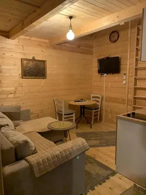 a living room with a couch and a table and a tv at Little Paradise in Virpazar