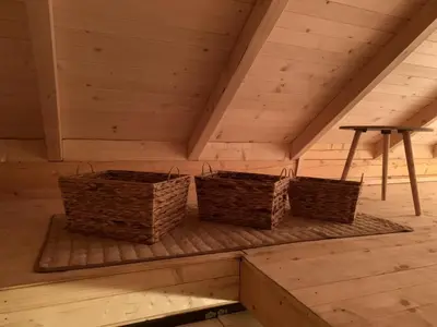 three baskets sitting on a shelf in a attic at Little Paradise in Virpazar