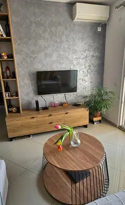 a living room with a table and a flat screen tv at Luda kuća in Bar