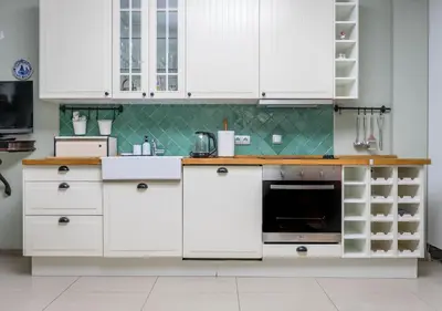 a kitchen with white cabinets and a sink at Villa Aurora in Petrovac na Moru