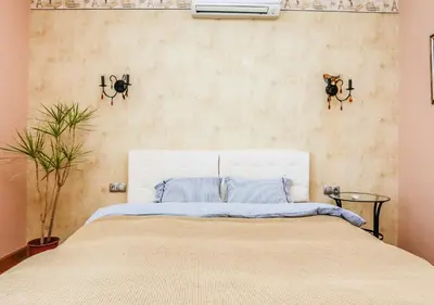 a bedroom with a white bed with blue pillows at Villa Aurora in Petrovac na Moru