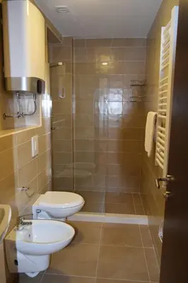 a bathroom with a toilet and a sink and a shower at Apartments Sea View in Kotor