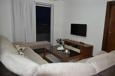 a living room with a white couch and a table at Apartments Sea View in Kotor
