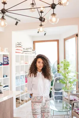 a woman standing in a clothing store at Sunset Hotel in Dobra Voda
