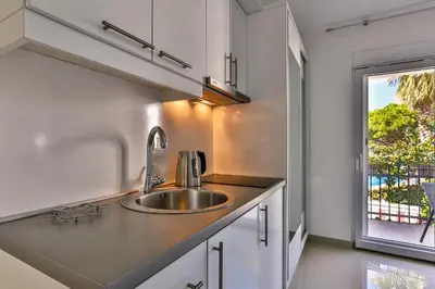 a kitchen with a sink and a window at Zelen LUX in Sutomore