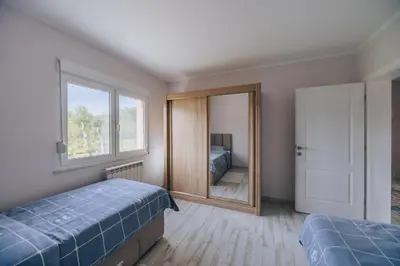 a bedroom with two beds and a mirror at Apartment Majstorina in Virpazar