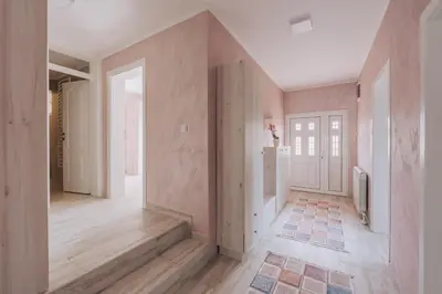 a hallway of a home with pink walls at Apartment Majstorina in Virpazar