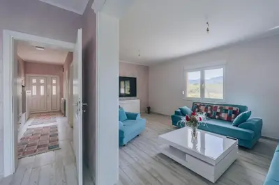 a living room with blue couches and a table at Apartment Majstorina in Virpazar