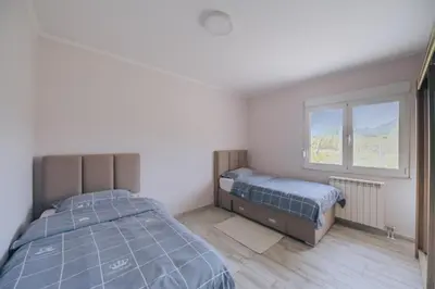 a bedroom with two beds and a window at Apartment Majstorina in Virpazar