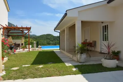 a house with a yard with a pool at Vila Pelinovo in Kotor